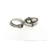 Two Tiffany silver rings. The heart ring is measuring approximately size L and the other measuring