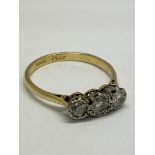 A 1920s 18ct gold and platinum 3 stone diamond ring.