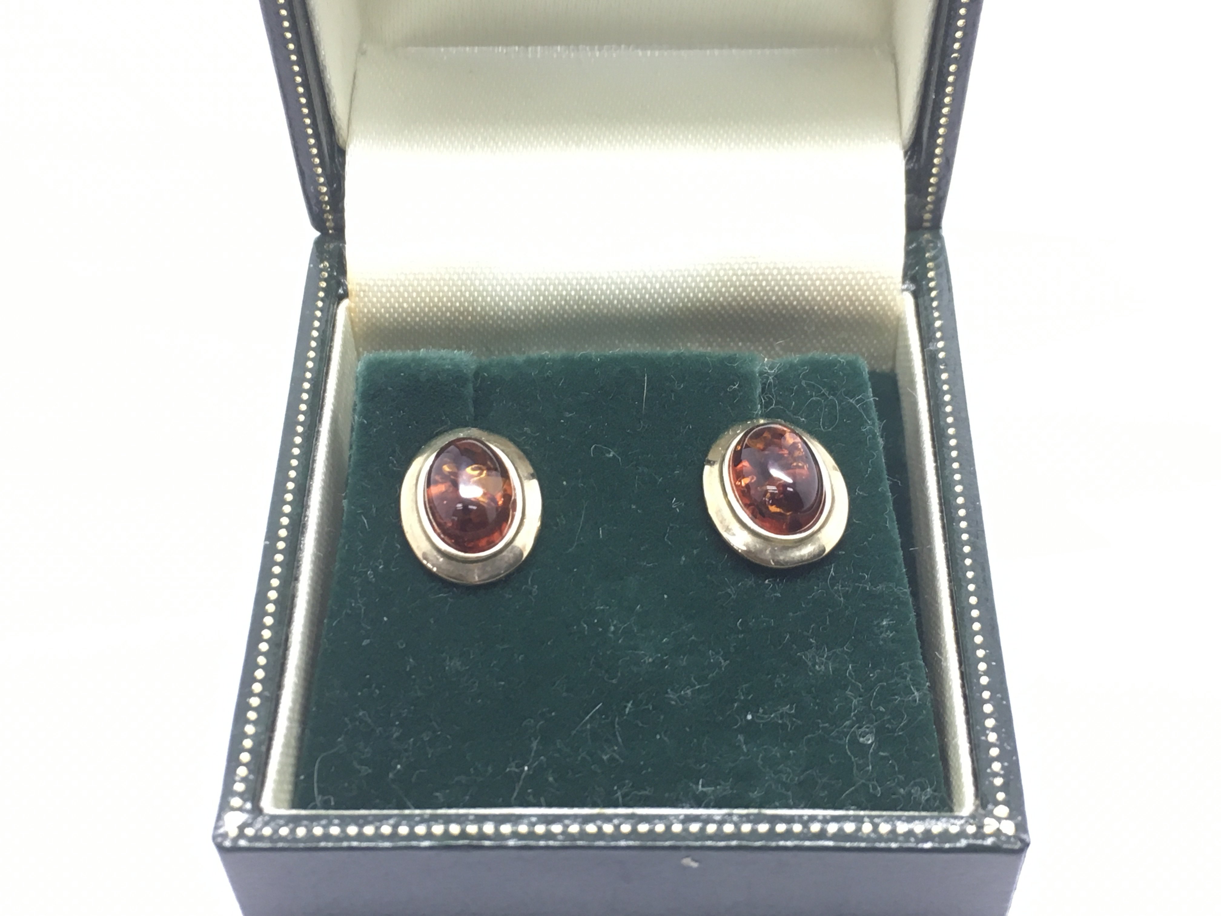 A pair of 9ct gold earrings set with amber, approx