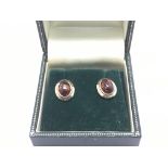 A pair of 9ct gold earrings set with amber, approx