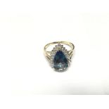 A pear shaped blue topaz with diamond cluster. Siz