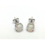 A pair of silver studs set with white Ethiopian op