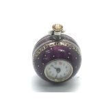 A 1920s silver and purple enamel ball shaped fob w