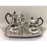 A silver plated tea set, a galleried tray and a cocktail shaker.