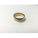 An 18ct gold plain band, measuring in ring size approximately L and weighing approximately 5g.