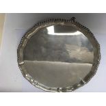 A silver salver with shaped edge on pad feet 1.120 Kg .london hallmarks
