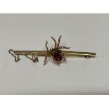 An Edwardian 9ct gold spider bar brooch set with a