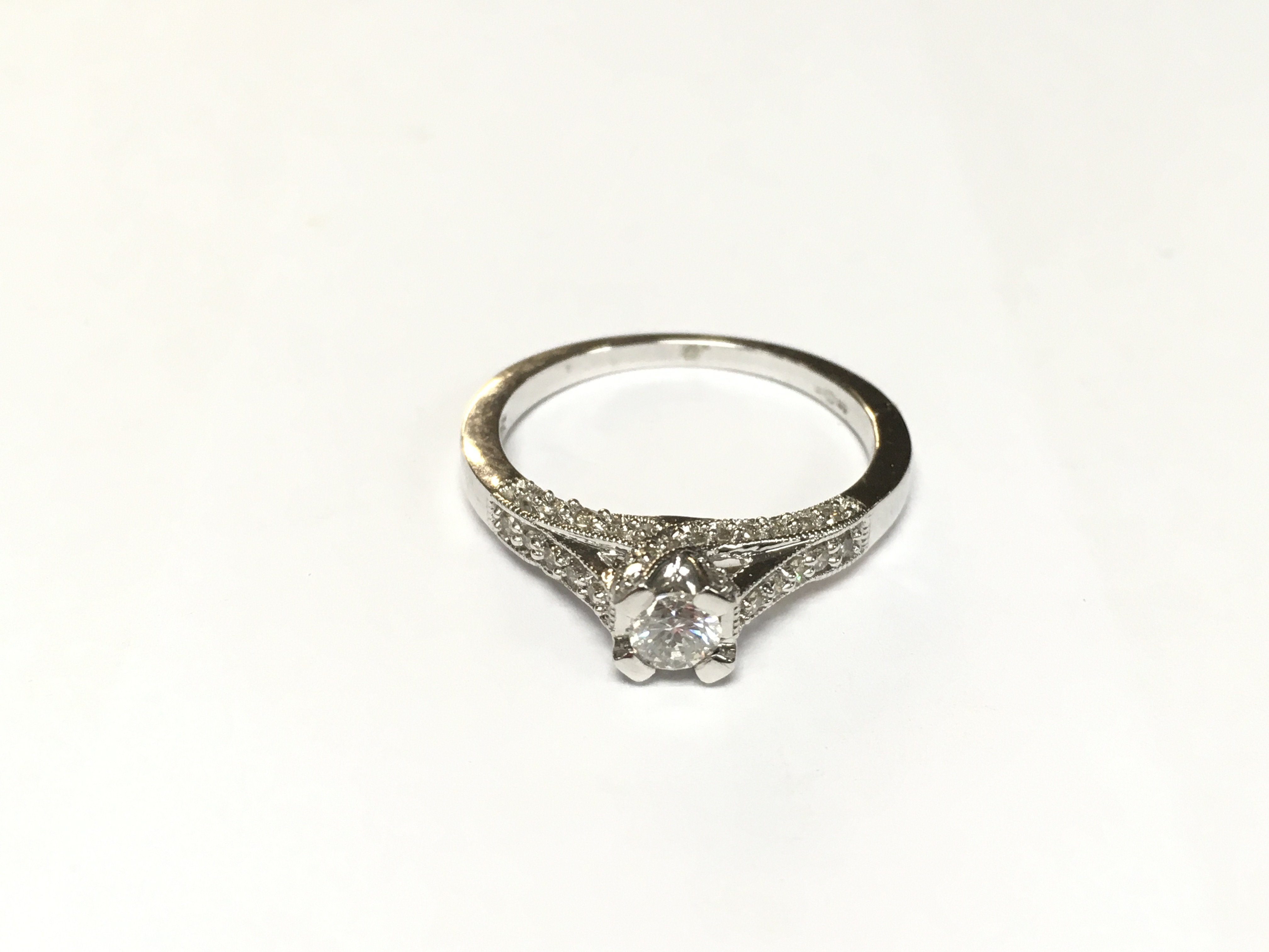 A very modern style diamond ring with diamond shou
