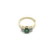 A 9ct gold ring set with an oval emerald (chipped)