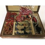A leather jewellery box containing a collection of
