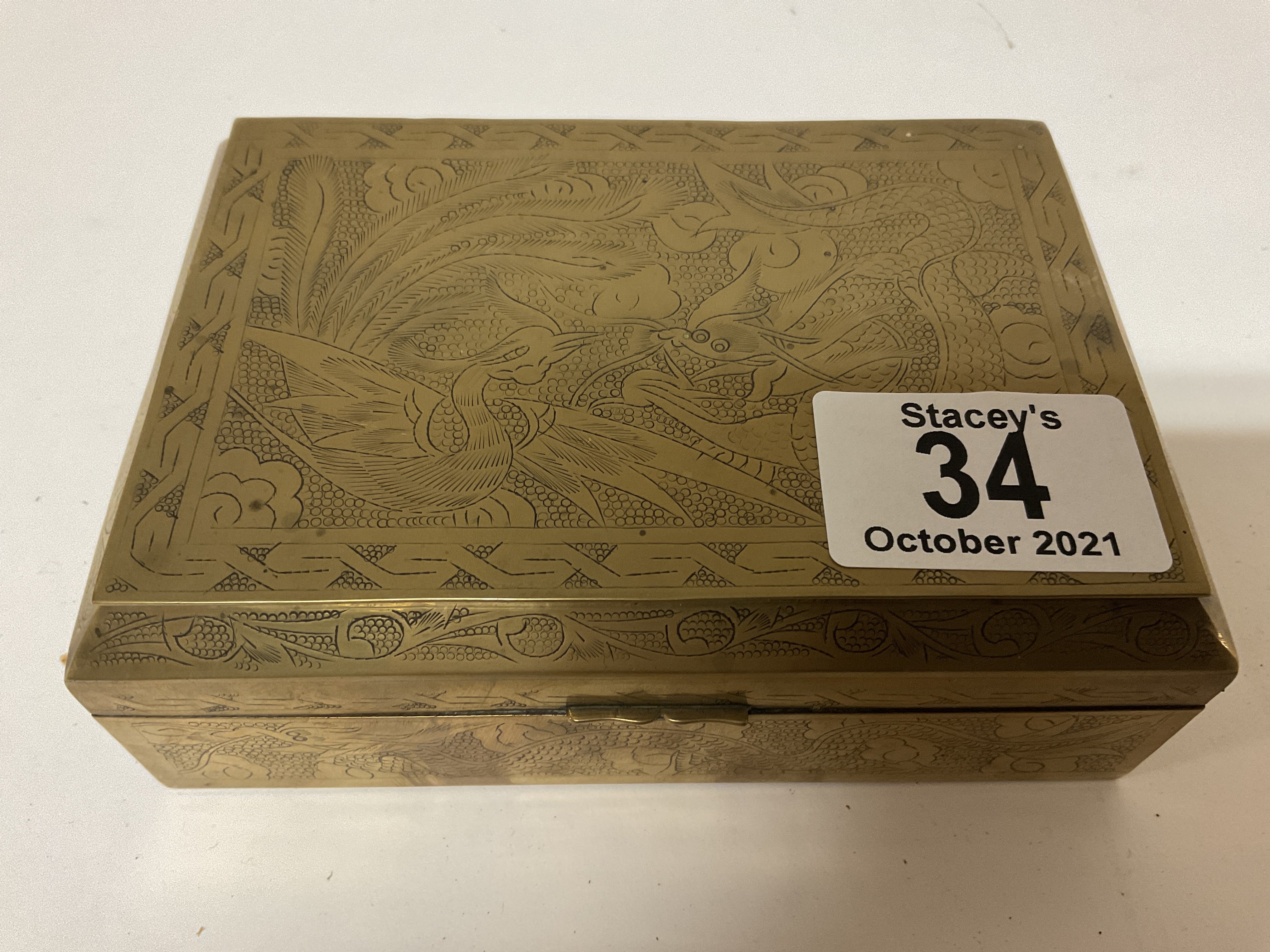 A small Chinese brass bound trinket box and conten