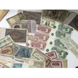 A collection of GB and world bank notes including 10 Shillings, a run of Â£1 notes, American Dollars