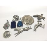 A collection of silver brooches. And stone set pen
