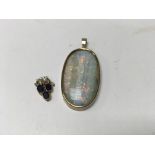 An oval pendant inset with coloured Opal stone and