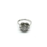 An Art Deco platinum ring, the central round old cut stone approx 2ct and flanked by four different