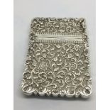 A heavy sterling silver card case with elaborate f