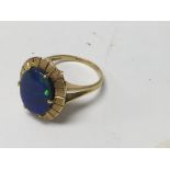 An unmarked gold ring inset with Opal coloured sto