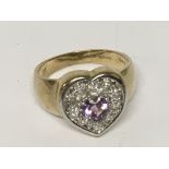 An amethyst and diamond heart ring set in gold. Ri