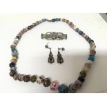 A Marcasite silver brooch and earring set and a good quality coloured bead necklace