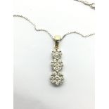 A 14k gold and diamond pendant on a 14k gold chain