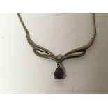 A 9carat gold necklace set with a ruby and small diamond.weight 3.4g
