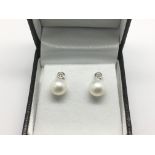 A pair of 18ct white gold drop stud earrings set w
