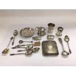 A small collection of silver items comprising a cigarette case, apostle spoons etc.
