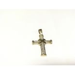 A 9ct gold stone set cross.