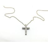 An 18ct white gold cross pendant on a white gold c