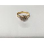 An unmarked gold ring set with a pattern of diamonds. The approximate ring size is between M and N.