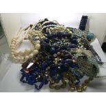 A collection of bead necklaces and bracelets of va