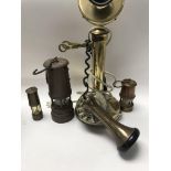 A brass stick telephone and three lamps .