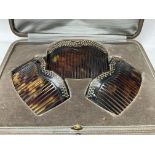 A cased 1920s tortoiseshell hair comb set with gold pique work decoration. ( some damage and