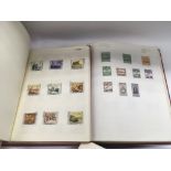A box of world stamps, loose and in albums.