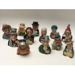 A collection of 12 Dickens House museum candle snuffers in the form of Dickens characters