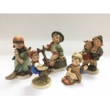 Five Hummel porcelain figures of children.