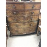 A Victorian mahogany bow fronted chest of drawers fitted with two short and four long drawers