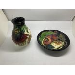 A Moorcroft pottery Pomegranate pattern pin dish together with a Lily design pot.