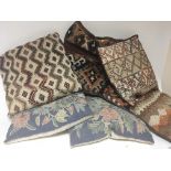 A collection of embroidered and other cushions. (a