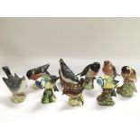 Nine small Bewsick figures of birds comprising Blu