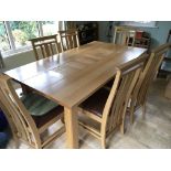 A modern light oak dining room suite with a set of six chairs with leather seats.(7)