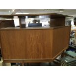 A modern design Teak bar with a raised top and glass sliding doors length approximately 120cm