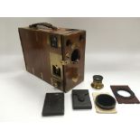 An antique brass bound half plate camera, tripod a