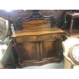 A William IV rosewood chiffonier with a raised back serpentine front above a drawer and cupboards