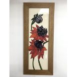 A framed Moorcroft tile, approx 14.5cm x 35cm incl