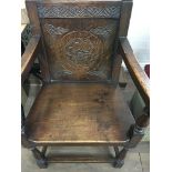 An oak open arm chair with carved back solid seat on turned legs ..