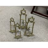 4 ornate brass picture frames.