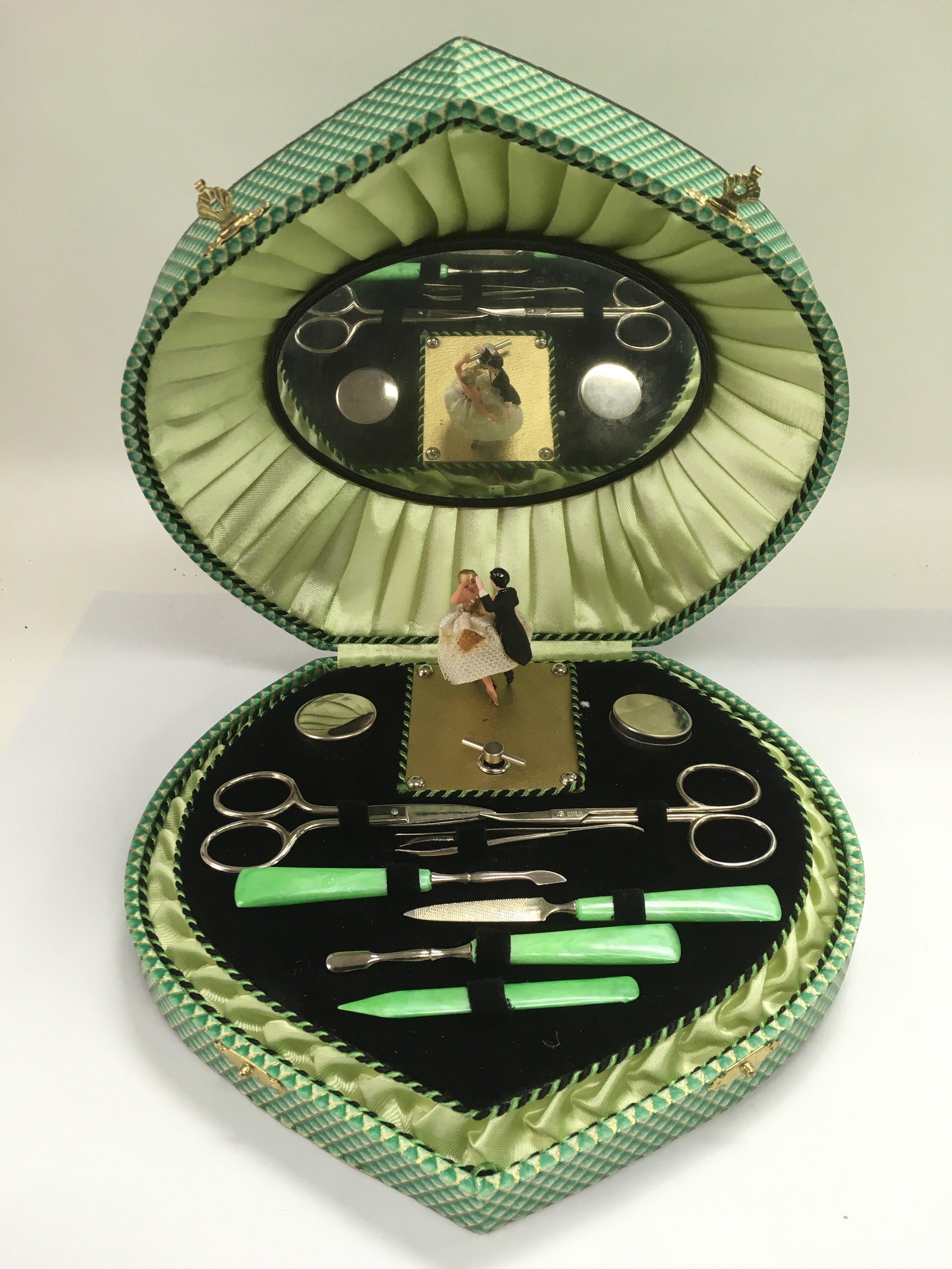 A 1950s cased manicure set with musical movement.