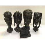 Four African carved busts of tribespeople together with a carved coalfigure of a miner (5).