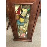 A small mahogany display cabinet containing advert